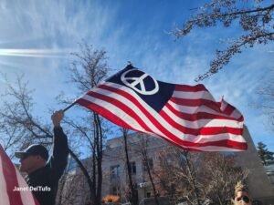 An American Flag with a peace sign.